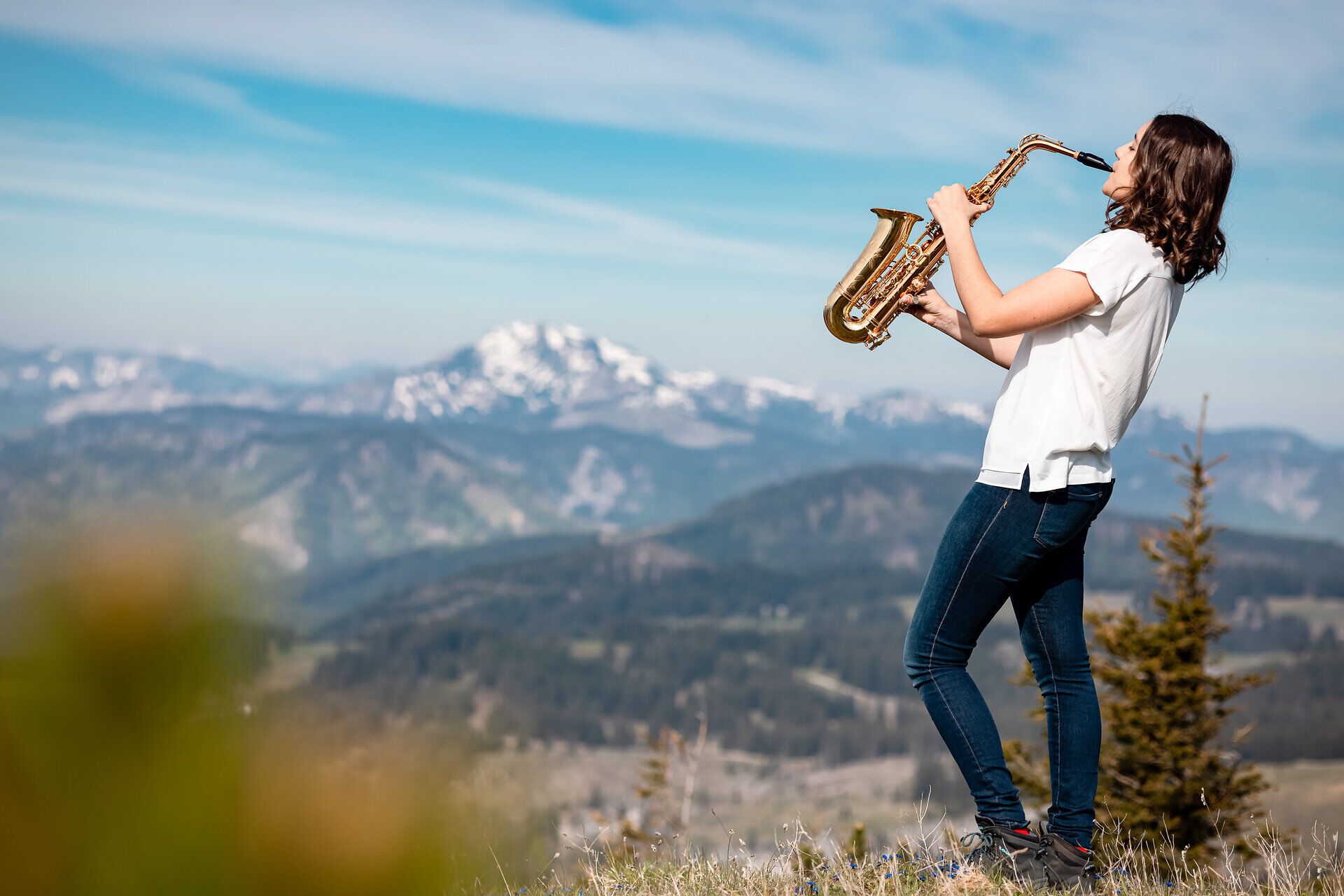 Inmitten der majestätischen Berge erklingt der sanfte Klang eines Saxophons, während die frische Bergluft die Sinne belebt. Die atemberaubende Aussicht auf die umliegenden Gipfel und das grüne Tal schafft eine harmonische Verbindung zwischen Musik und Natur. Ein unvergesslicher Moment, der die Seele berührt und zum Verweilen einlädt.