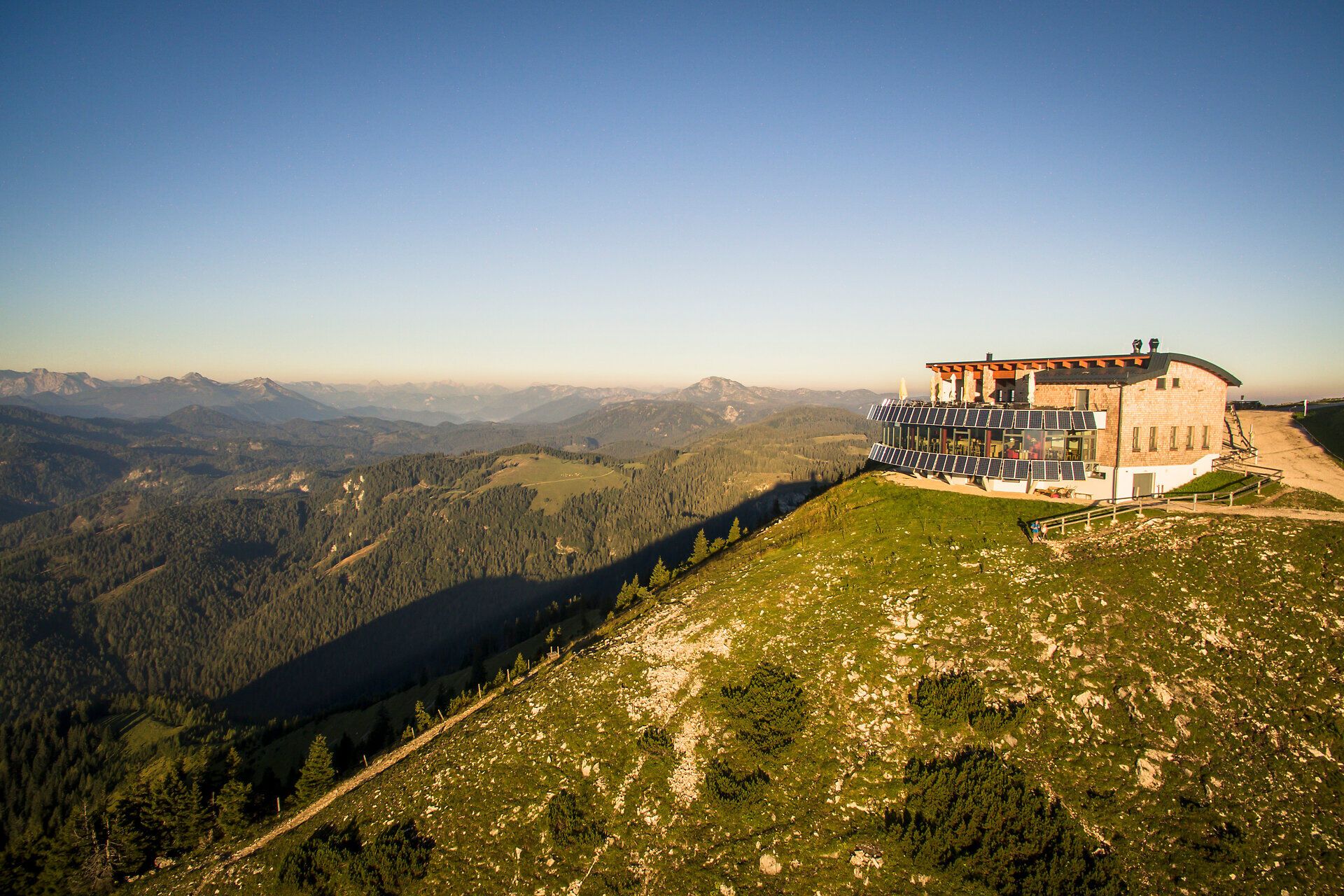 Die sanften Hügel und majestätischen Berge umarmen die Landschaft, während die Sonne sanft über die Gipfel strahlt. Ein Ort der Ruhe und Erholung, wo die frische Bergluft und die atemberaubenden Ausblicke zum Verweilen einladen. Hier wird der Sommer in den Bergen zum unvergesslichen Erlebnis.